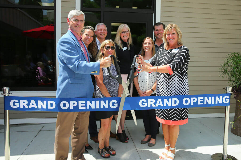 BUGZ0159 staff cutting the grand opening ribbon