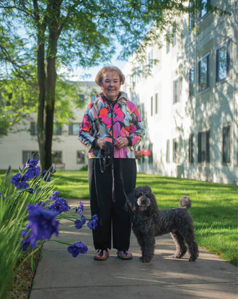 WL2_7732 senior woman standing outside with her dog