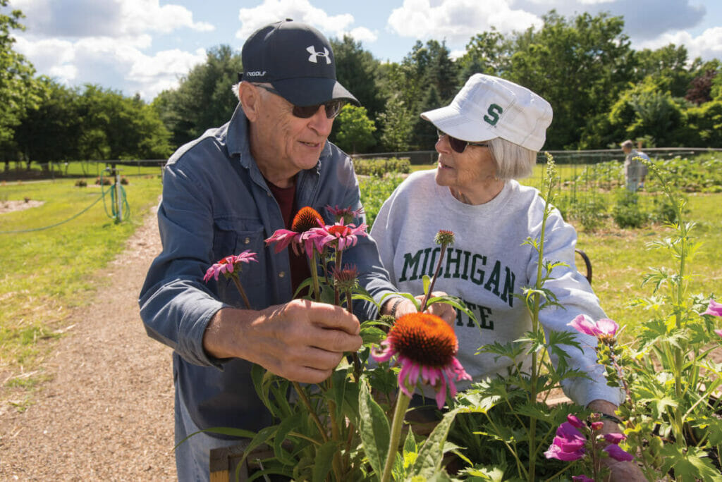 WL2_7959 seniors looking at flower blooms