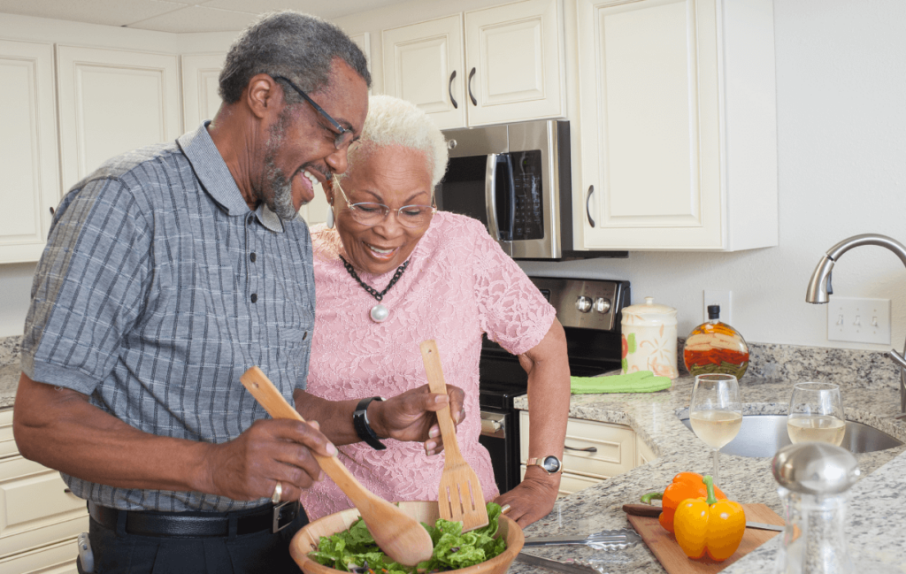 Senior couple making a salad together