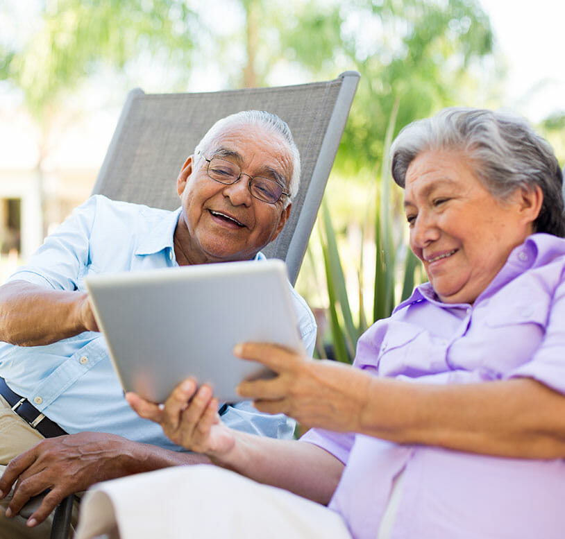 senior couple looking at their tablet