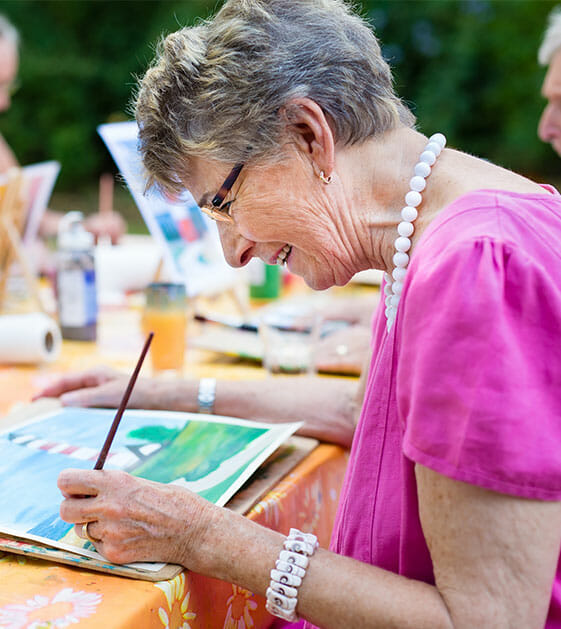 senior woman painting a picture