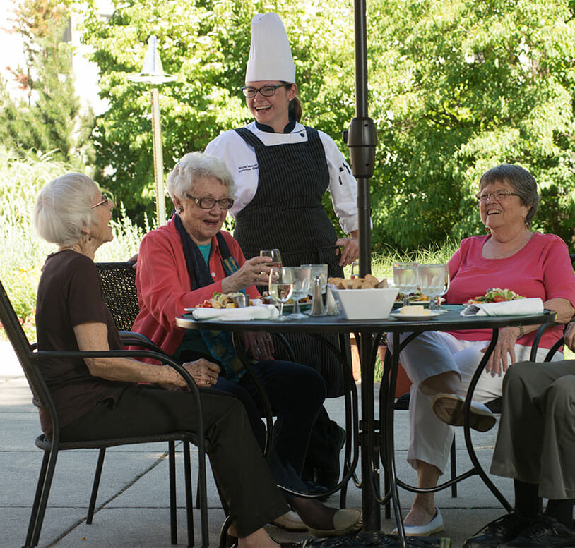 senior women talking to the chef at dinner