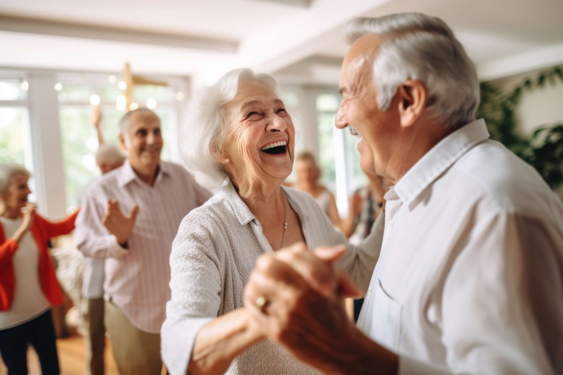 senior man and woman dance and laugh at a party